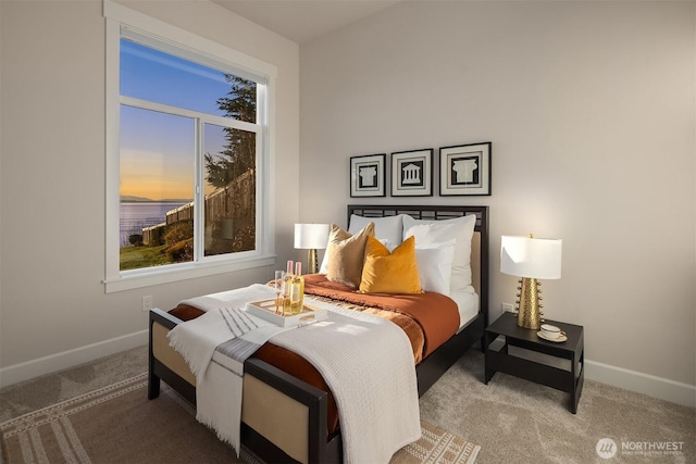 carpeted bedroom featuring baseboards