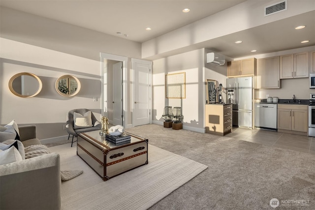 living area with recessed lighting, light colored carpet, visible vents, baseboards, and a wall mounted AC