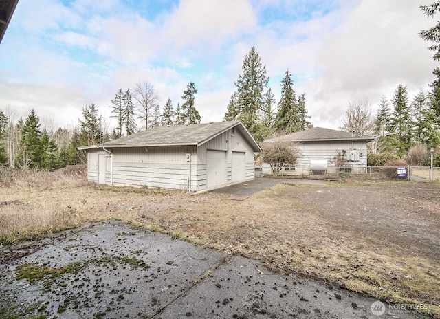 detached garage featuring fence