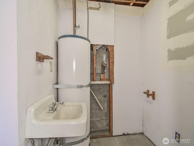 bathroom with unfinished concrete flooring and a sink