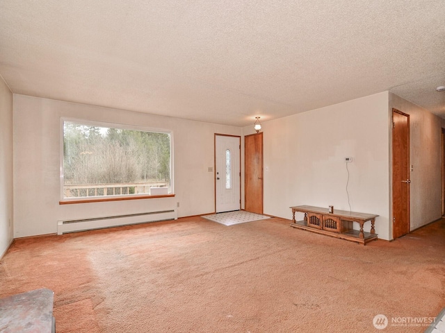 interior space featuring a textured ceiling, carpet floors, and a baseboard radiator