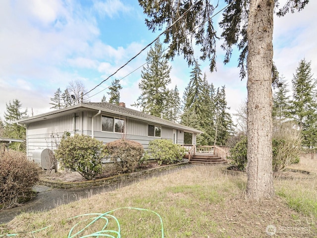 view of property exterior with a deck and a chimney