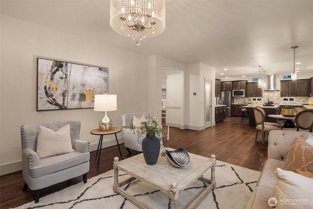 living room with a notable chandelier, recessed lighting, baseboards, and wood finished floors