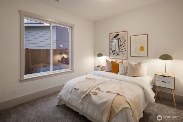 carpeted bedroom featuring baseboards