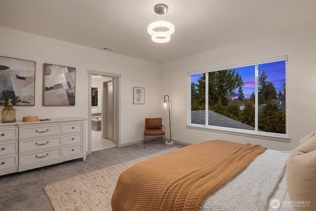 bedroom with light colored carpet and baseboards