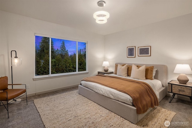 bedroom with baseboards and carpet