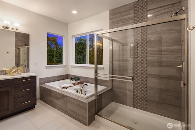 full bath featuring vanity, a shower stall, a bath, and tile patterned floors