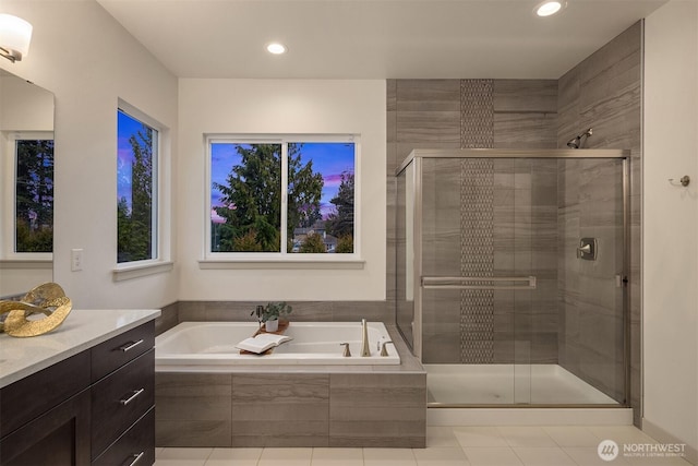 bathroom featuring a stall shower, recessed lighting, a bath, and vanity