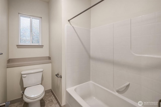 bathroom featuring tub / shower combination, toilet, and baseboards