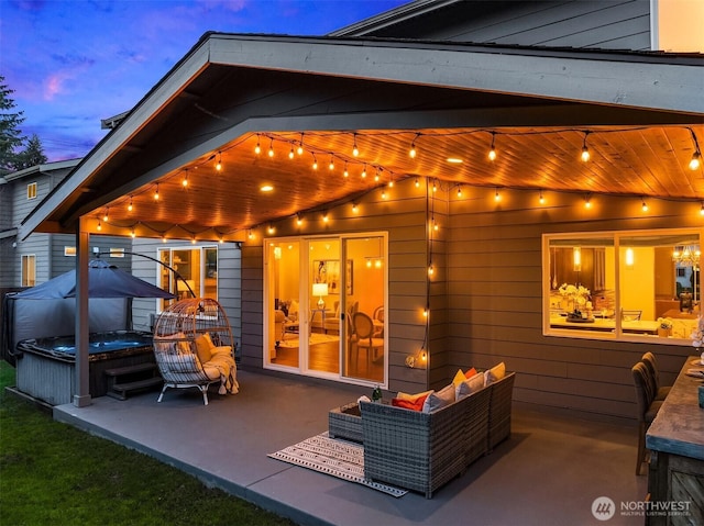 back of property featuring a hot tub, outdoor lounge area, and a patio