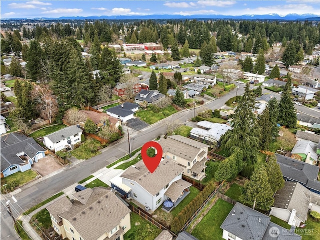 aerial view featuring a wooded view and a residential view