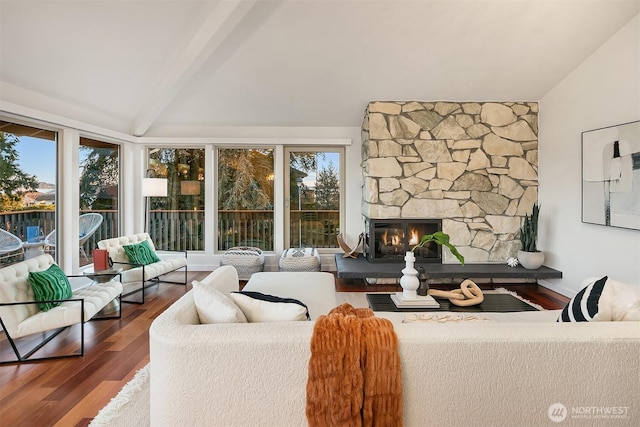 living room featuring a fireplace, wood finished floors, baseboards, and vaulted ceiling