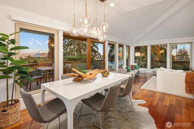 sunroom / solarium with lofted ceiling and a chandelier