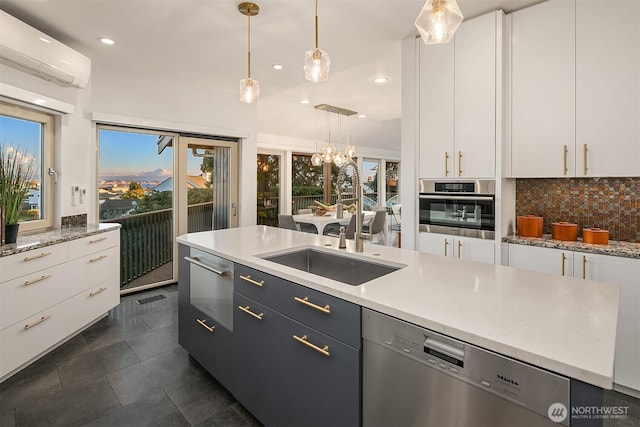 kitchen featuring a wall mounted AC, a sink, decorative backsplash, stainless steel appliances, and a warming drawer