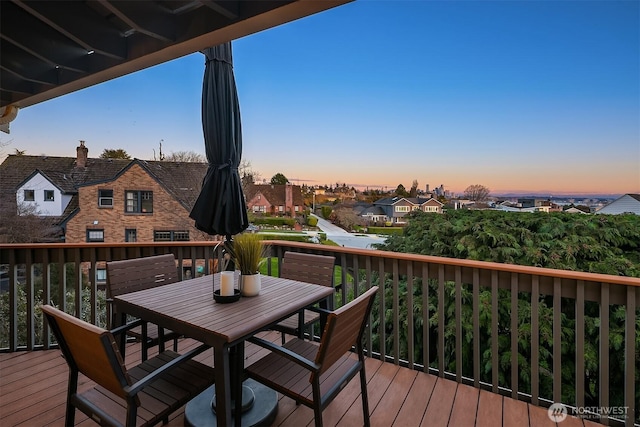 wooden deck with outdoor dining area and a residential view