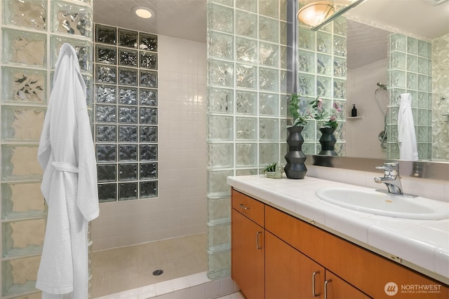 bathroom with walk in shower and vanity