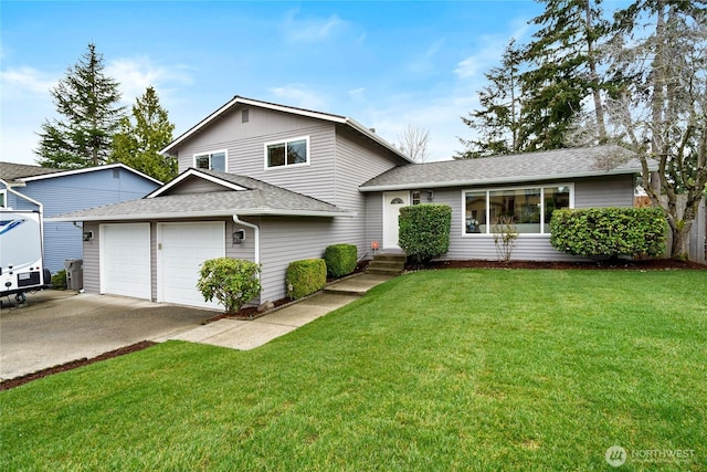 tri-level home featuring concrete driveway, roof with shingles, an attached garage, and a front lawn