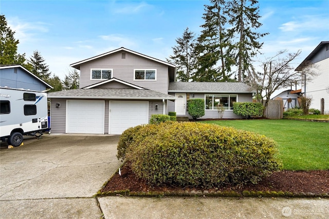 split level home with driveway, a shingled roof, and a front yard