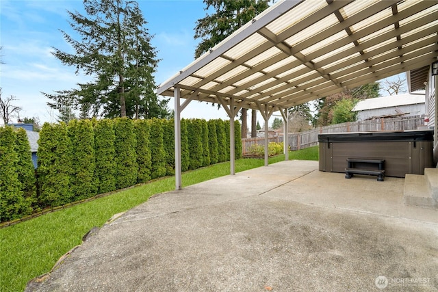 view of patio featuring a hot tub and a fenced backyard