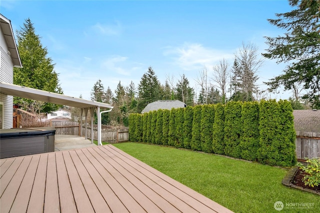 wooden terrace with a yard, a fenced backyard, and a hot tub