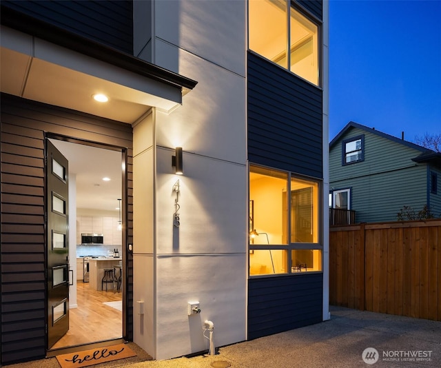 doorway to property featuring fence