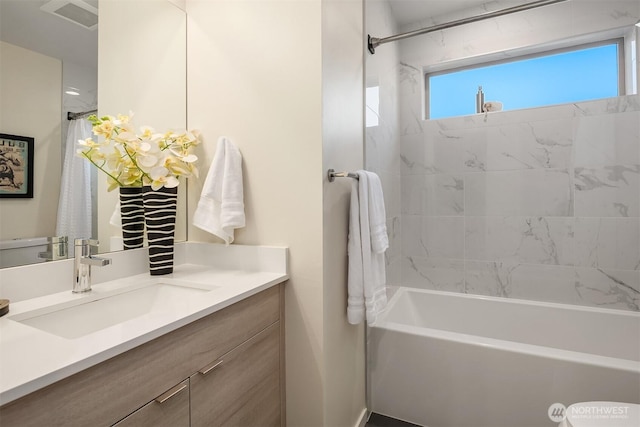 bathroom featuring shower / bath combination with curtain, visible vents, and vanity