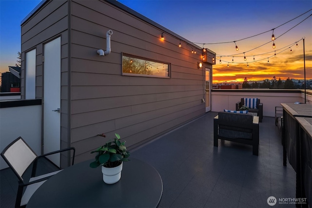 property exterior at dusk featuring an outdoor living space