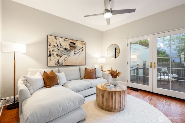 living room with french doors, visible vents, ceiling fan, wood finished floors, and baseboards