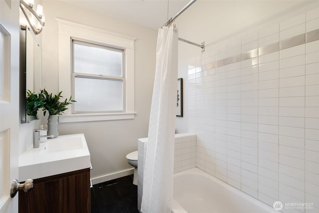 bathroom featuring shower / bath combo, baseboards, vanity, and toilet