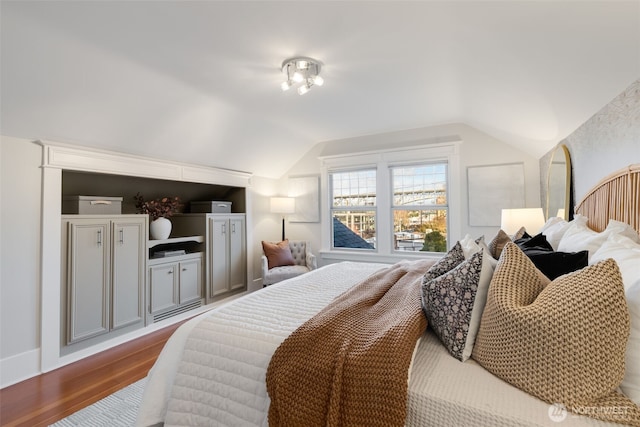 bedroom featuring vaulted ceiling and wood finished floors