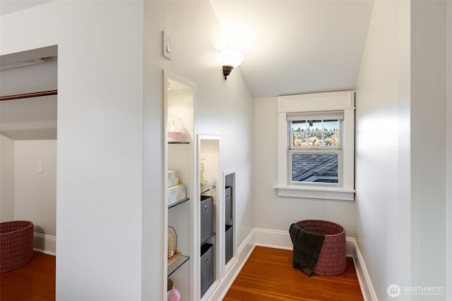 interior space with baseboards and wood finished floors