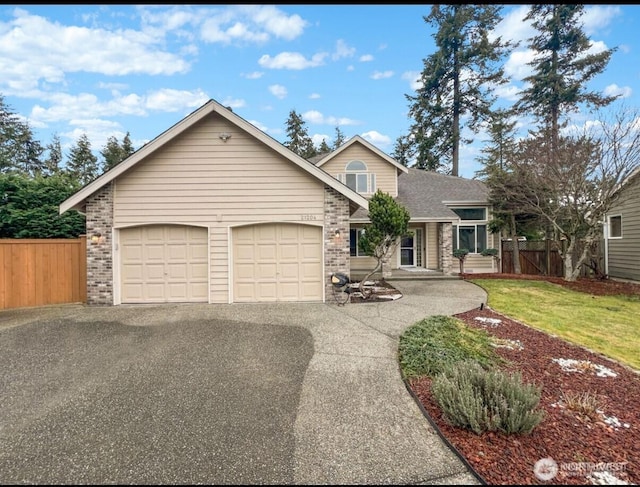 view of front of property featuring aphalt driveway, brick siding, an attached garage, and fence