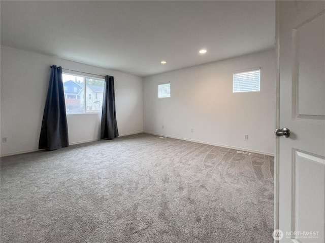 carpeted spare room featuring recessed lighting and baseboards