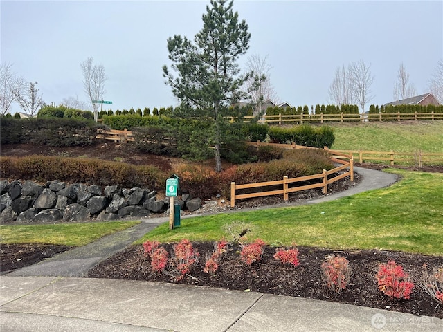 view of yard with a rural view and fence