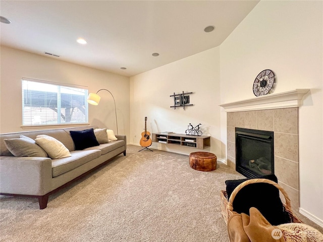 living area with visible vents, recessed lighting, carpet floors, baseboards, and a tile fireplace