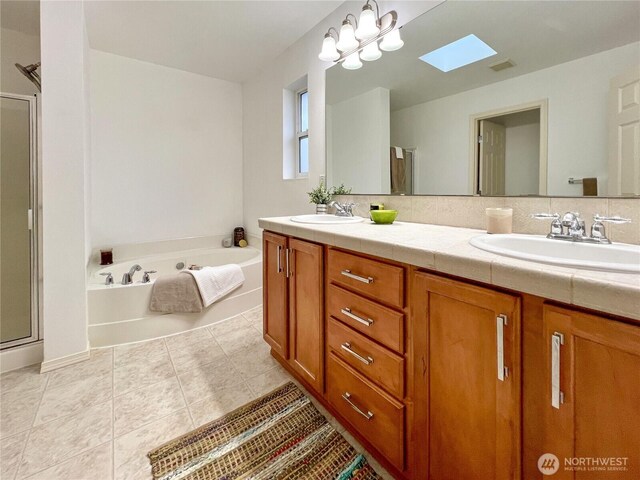 full bath with a shower stall, a bath, double vanity, and a sink