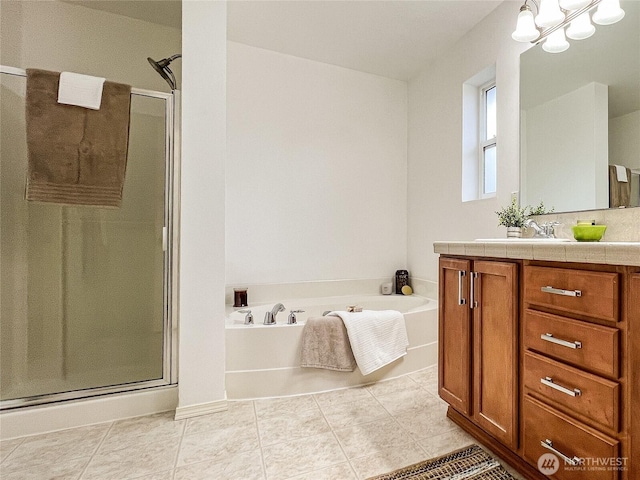 bathroom with tile patterned floors, a stall shower, vanity, and a garden tub