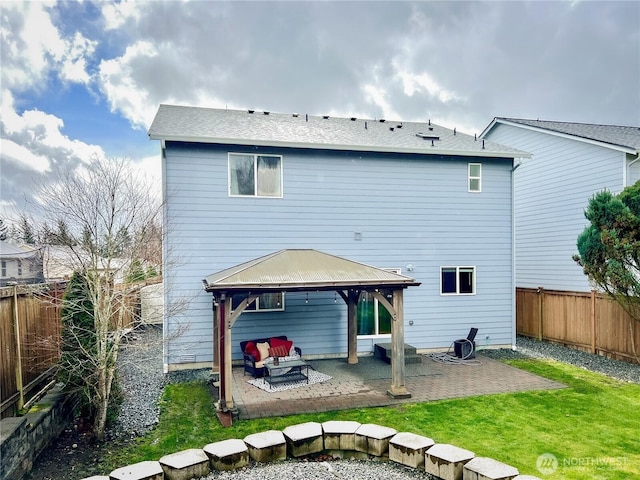 back of property with a gazebo, a yard, a patio, and a fenced backyard