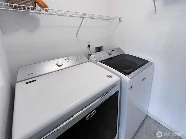 laundry area featuring washing machine and clothes dryer and laundry area