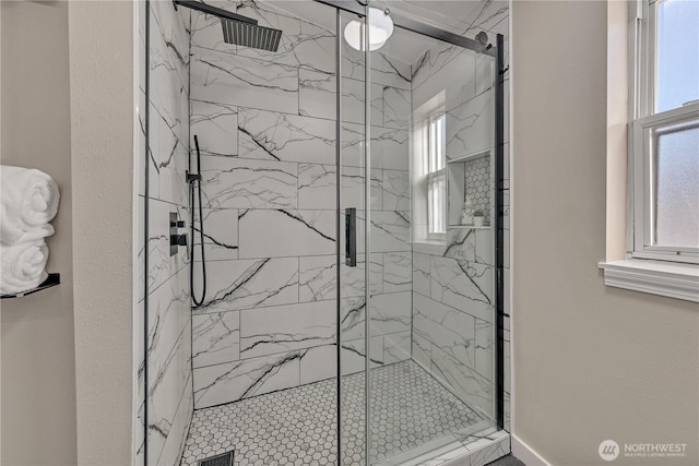 full bath with a wealth of natural light and a marble finish shower