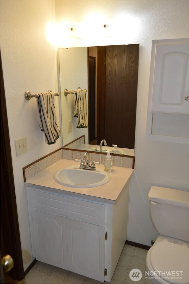 half bathroom with toilet and vanity