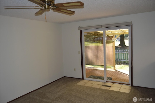 spare room with light carpet, a textured ceiling, and baseboards