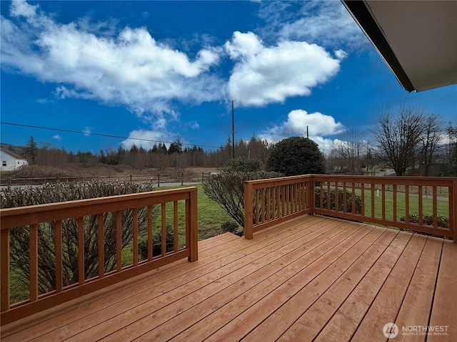 wooden deck with a yard and fence