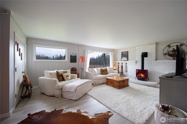 living area featuring a wood stove and wood finished floors