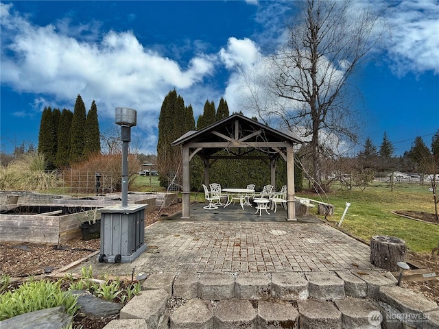 view of patio featuring a gazebo and a vegetable garden