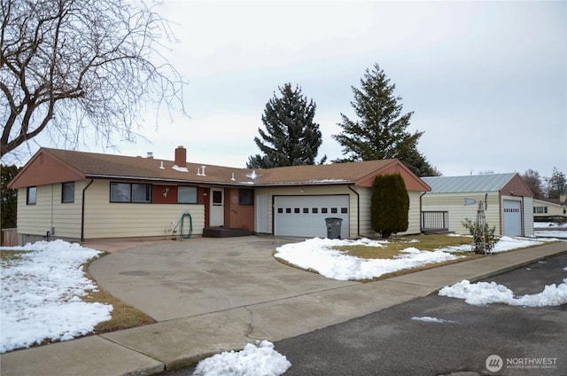 ranch-style home featuring a chimney and an attached garage