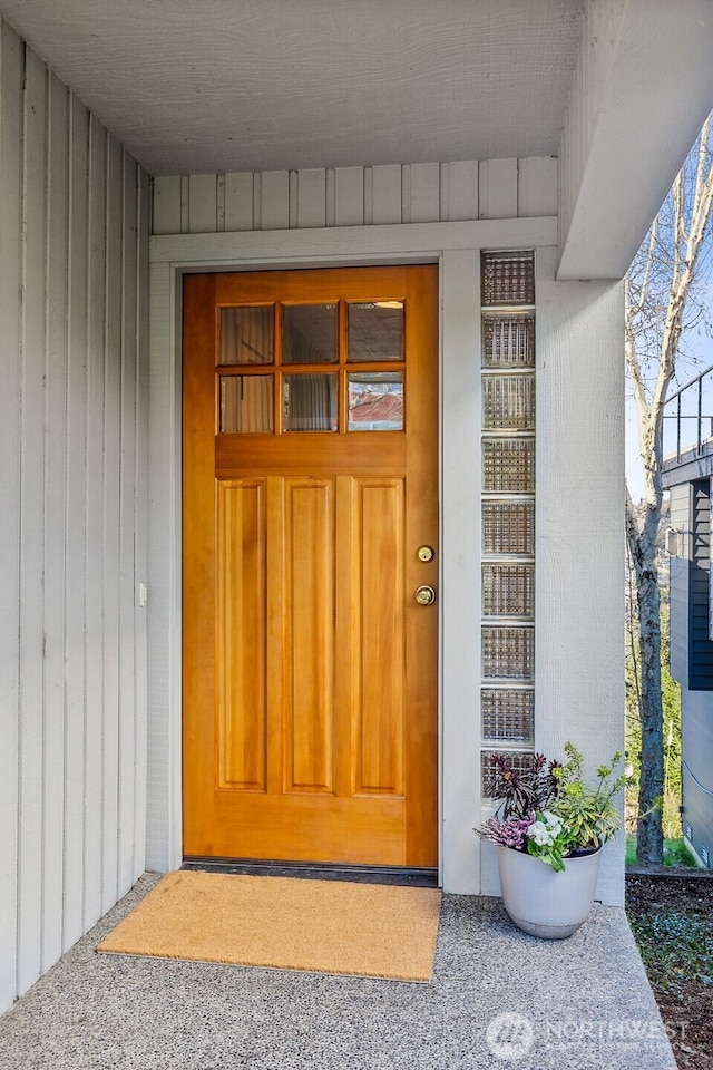 doorway to property featuring board and batten siding