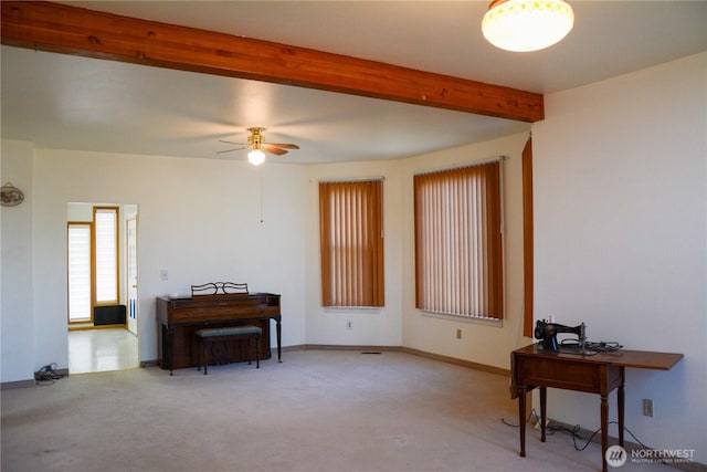 living area with carpet, beam ceiling, ceiling fan, and baseboards