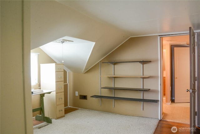 bonus room featuring lofted ceiling, wood finished floors, and visible vents