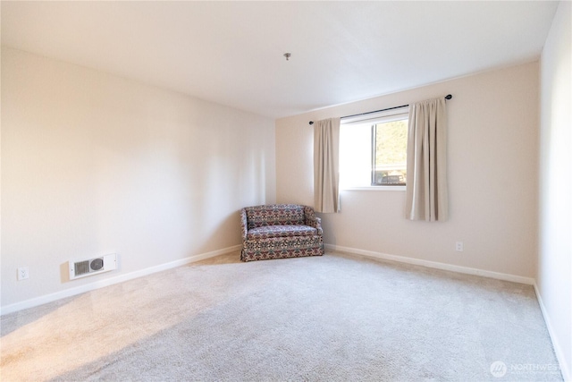 unfurnished room featuring carpet, visible vents, and baseboards